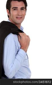 Successful businessman posing with jacket over shoulder