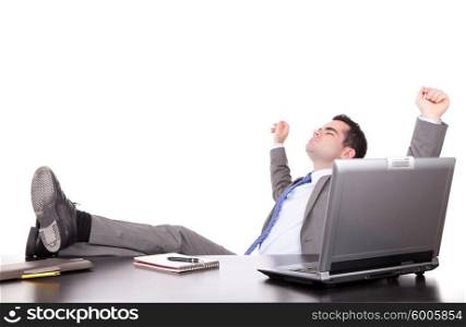 Successful businessman relaxing over desk, isolated