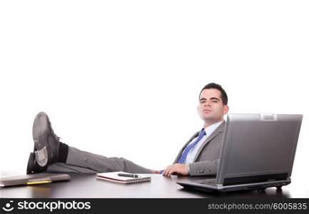 Successful businessman relaxing over desk, isolated in white background
