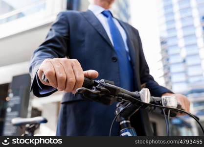 Successful businessman riding bicycle. Successful businessman in suit riding bicycle