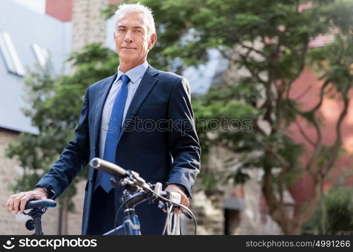 Successful businessman riding bicycle. Successful businessman in suit riding bicycle