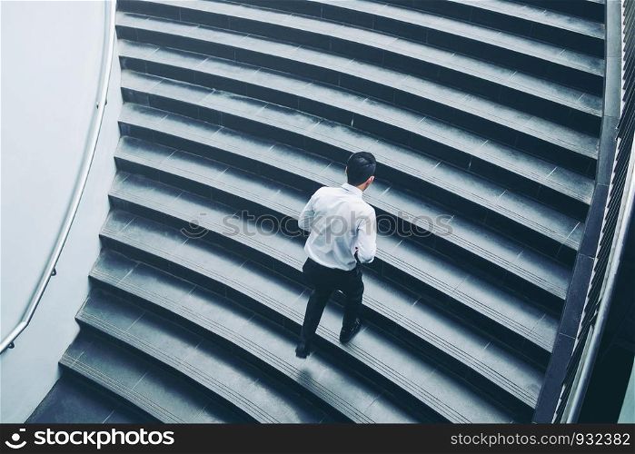 Successful businessman running fast upstairs Success concept