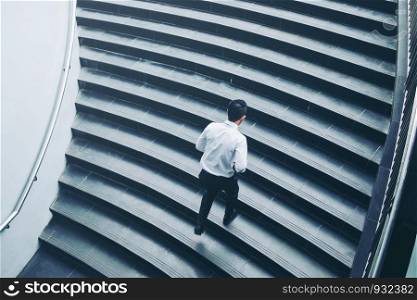 Successful businessman running fast upstairs Success concept