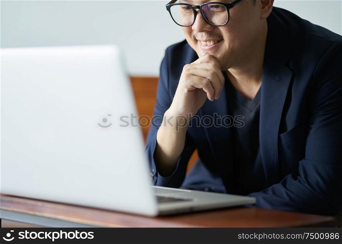 Successful businessman smile in front of the computer , selective focusing .