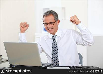 Successful businessman with arms up