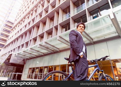 Successful businessman with bicycle. Successful businessman in suit with bicycle in city