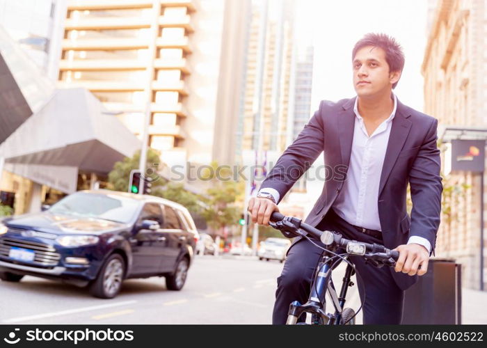 Successful businessman with bicycle. Successful businessman in suit with bicycle in city