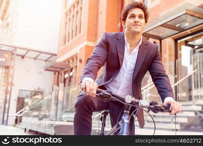 Successful businessman with bicycle. Successful businessman in suit with bicycle in city