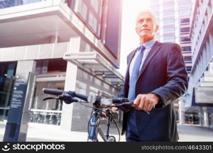 Successful businessman with bicycle. Successful businessman in suit with bicycle in city