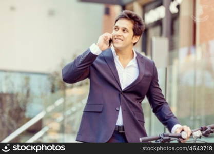 Successful businessman with bicycle. Successful businessman in suit with bicycle in city