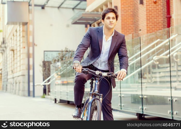 Successful businessman with bicycle. Successful businessman in suit with bicycle in city