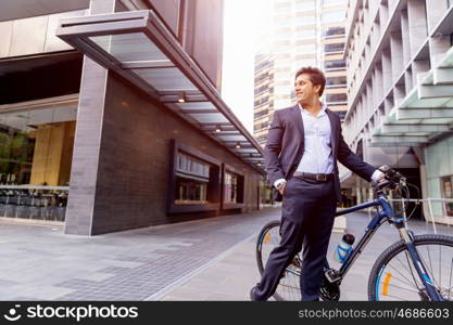 Successful businessman with bicycle. Successful businessman in suit with bicycle in city