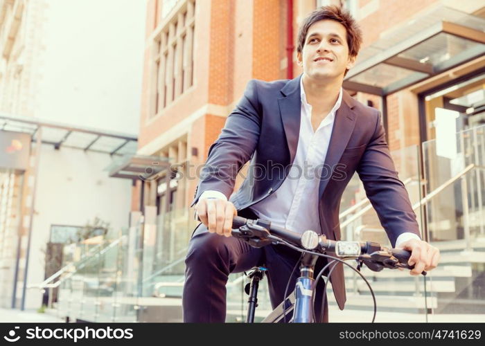 Successful businessman with bicycle. Successful businessman in suit with bicycle in city