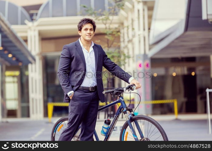 Successful businessman with bicycle. Successful businessman in suit with bicycle in city