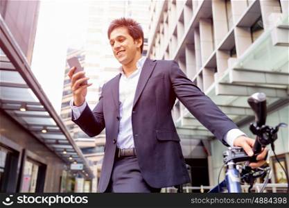 Successful businessman with bicycle. Successful businessman in suit with bicycle in city