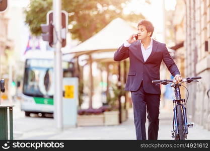 Successful businessman with bicycle. Successful businessman in suit with bicycle in city