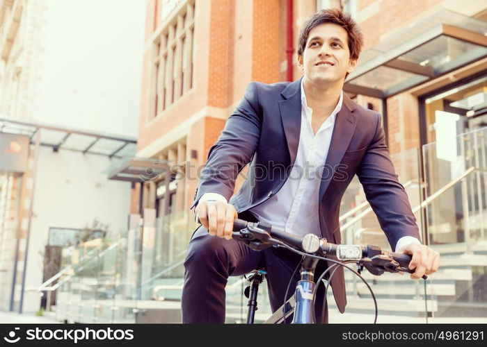 Successful businessman with bicycle. Successful businessman in suit with bicycle in city