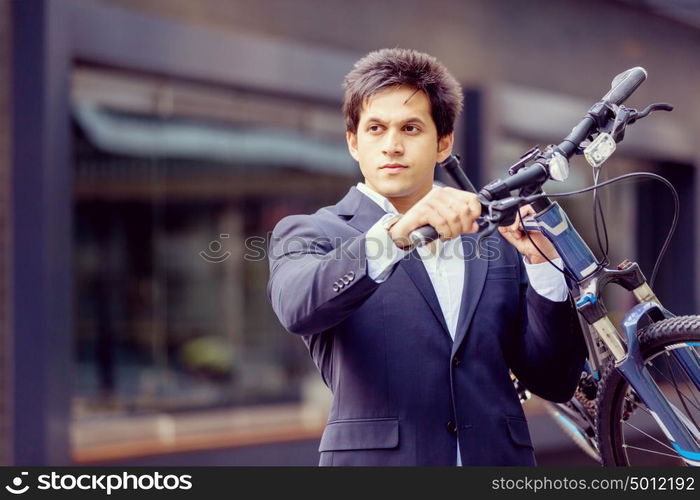 Successful businessman with bicycle. Successful businessman in suit with bicycle in city