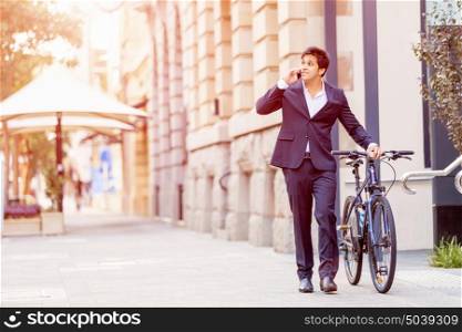 Successful businessman with bicycle. Successful businessman in suit with bicycle in city