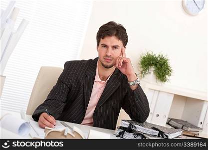 Successful businessman working in black suit at office