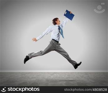 Successful businessman. Young businessman in jump against blank background