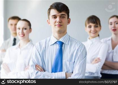Successful businessman. Young smiling businessman with colleagues. Leadership concept