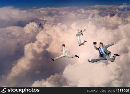 Successful businesspeople. Image of businesspeople jumping high in sky