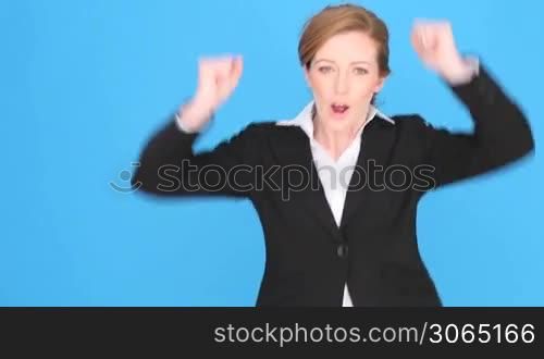 Successful businesswoman giving Thumbs Up for approval, success, or hope, isolated on blue with copyspace