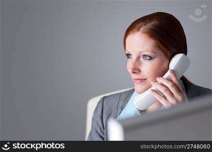 Successful businesswoman on the phone at office calling