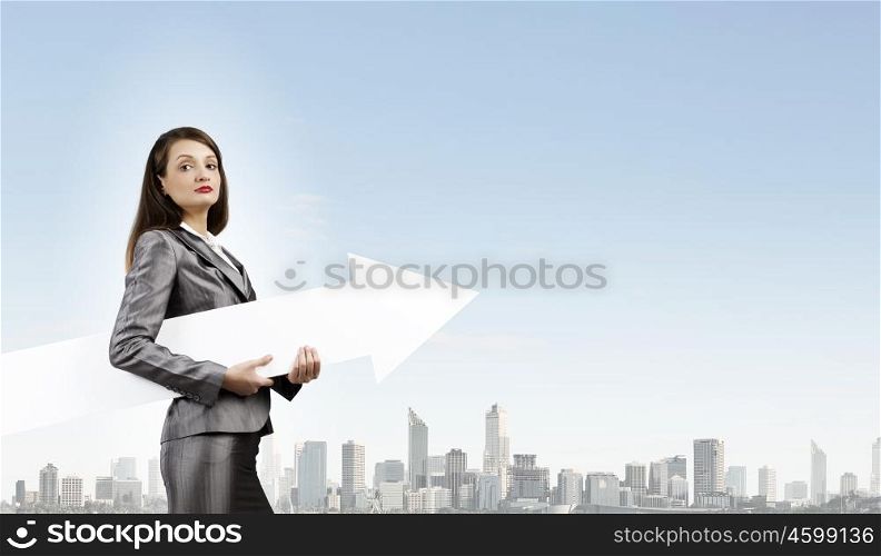 Successful businesswoman. Young businesswoman in suit with increasing arrow in hand