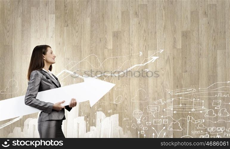 Successful businesswoman. Young businesswoman in suit with increasing arrow in hand