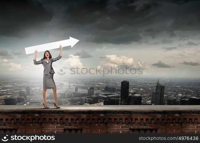 Successful businesswoman. Young businesswoman in suit with increasing arrow in hand