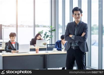 Successful company,executive Young Asian businessman partners with happy workers Group of asian business people with diverse genders  LGBT  in the meeting room at office