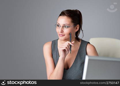 Successful executive businesswoman thinking at office, holding pen
