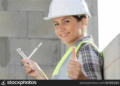 successful female architect shows thumb up