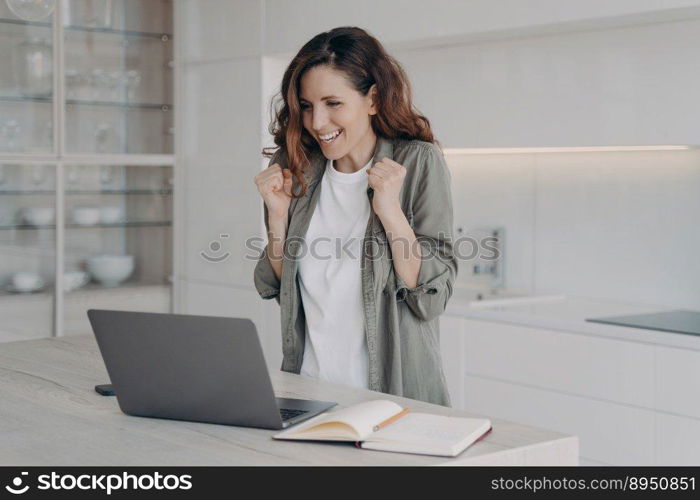 Successful female freelancer wins. Young caucasian woman says yes. Overjoyed lady has corporate internet session on laptop. Girl staying home on quarantine. Remote work and communication.. Successful female freelancer wins. Young caucasian woman says yes. Internet session on laptop.