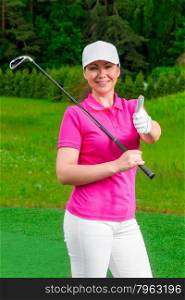 successful golfer happy woman standing with a golf club