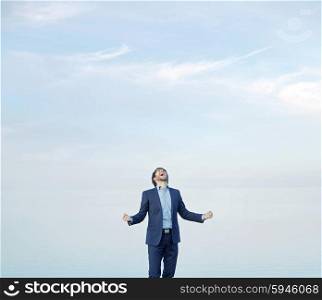 Successful guy over the sky background