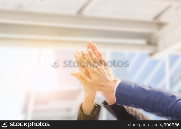 Successful hand of business team giving a high fives gesture with clipping path blurred background, Success Teamwork Togetherness Collaboration Concept.