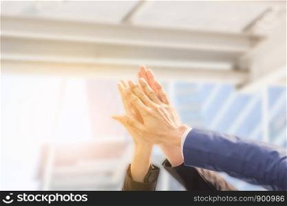 Successful hand of business team giving a high fives gesture with clipping path blurred background, Success Teamwork Togetherness Collaboration Concept.
