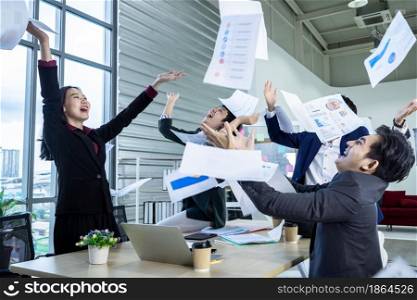 Successful happy workers Group of asian business people with diverse genders (LGBT) threw up the business plan in document paper into the air in the meeting room at office,emotionally satisfied with