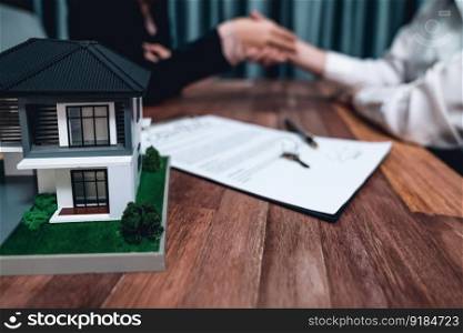 Successful house loan agreement sealed with a handshake. Buyers and agents celebrate the home ownership of property with a sense of accomplishment and satisfaction. Enthusiastic. Successful house loan agreement sealed with a handshake. Enthusiastic