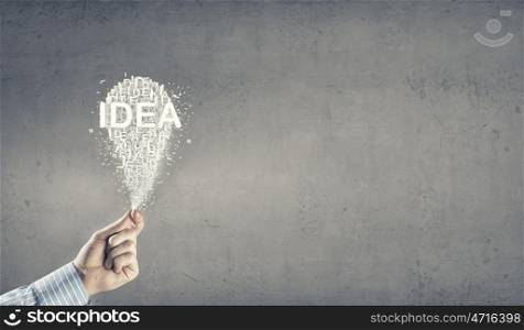 Successful idea. Close up of hand showing with gesture on light bulb