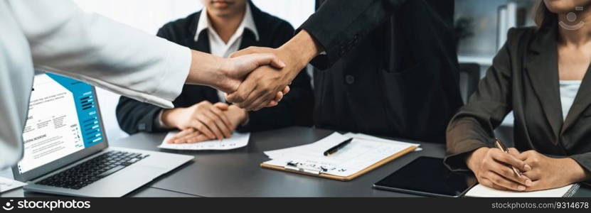 Successful job interview at business office end with handshake as the hired candidate seals the deal with the HR team recruiter by handshaking after successful interview. Panorama shot. Prodigy. Successful job interview at business office end with handshake. Prodigy