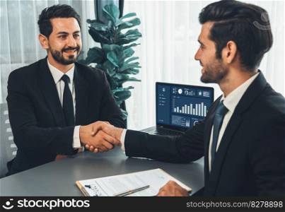 Successful job interview at business office with handshake. Positive discussion of qualifications and application for position. Job hiring concept between candidate and interviewer. Fervent. Successful job interview at business office with handshake. Fervent