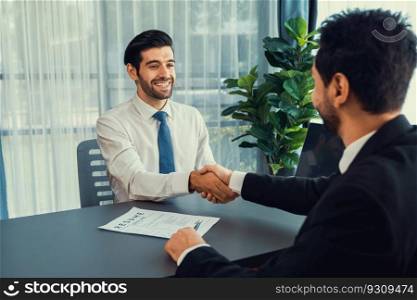Successful job interview at business office with handshake. Positive discussion of qualifications and application for position. Job hiring concept between candidate and interviewer. Fervent. Successful job interview at business office with handshake. Fervent