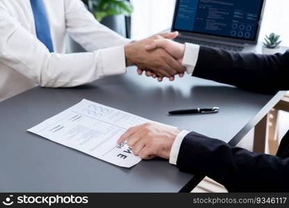 Successful job interview at business office with handshake. Positive discussion of qualifications and application for position. Job hiring concept between candidate and interviewer. Fervent. Successful job interview at business office with handshake. Fervent