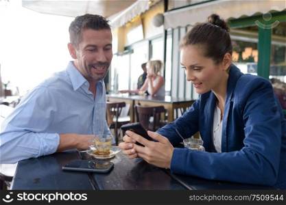 successful man and woman barista in restaurant