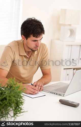 Successful modern businessman with laptop sitting at the office