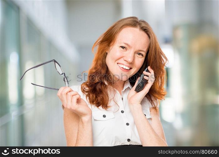 Successful secretary talking on the phone with a client company